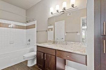 A bathroom with a toilet sink and bathtub